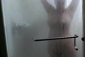 Black haired MILF showers in hotel room