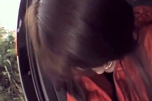 In a red down jacket with nylons, masturbating