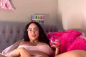 Ebony pornstar Badkittyyy likes to dangle her shaved pussy when she performs webcam