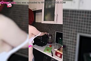 Beautiful red-haired beauty in beautiful underwear has fun in the kitchen