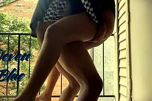 Ebony teen enjoying her man’s large cock by riding on the balcony