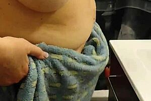 A redhead housewife strips off and takes a bath