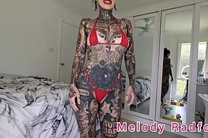One of the many big boobed amateur Melody Radford who tries on red and black micro bikinis
