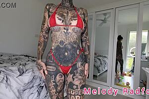 One of the many big boobed amateur Melody Radford who tries on red and black micro bikinis