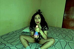 In the dark, a young Latina girl plays with her toy
