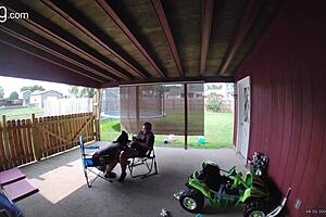 In daylight Wife performing blowjob to her husband in the back porch area where everybody could see