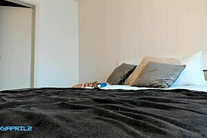 A young Latina woman masturbates herself with a huge dildo and her hand using the doggy style position