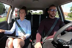 A European woman who has blonde hair provides a blow job to her driving teacher in the car