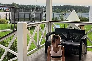 A video of a smiling and attractive neighbor performing morning set of as a wake up call
