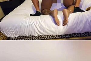 An African American woman with full hips and a tongue pierced gets a facial