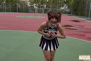 Public naughty young cheerleader takes the cum in her mouth