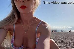 When a blonde is on a public beach, watching her juicy boobs and elastic ass