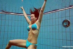 Deniska, busty teen, relishes a refreshing swim in the pool