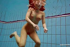 Deniska, busty teen, relishes a refreshing swim in the pool