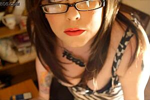 British curvaceous woman Tina Snuwa enjoys smoking two cigarettes while wearing glasses.