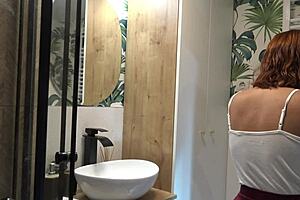 Redhead girlfriend shows her ass in the bathroom in a mini skirt