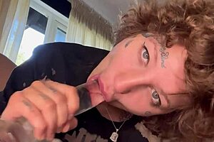 A girl with tattoos gives rough blow job until she cries and then sucks a dildo.