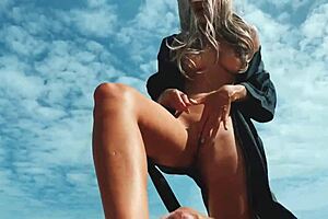 A blonde girl has a foot fetish and while giving a foot job, she also masturbates and has the man cum on her feet at a public nude beach.
