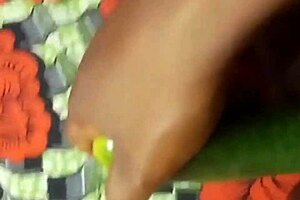 Close up and personal with a black pussy and a cucumber