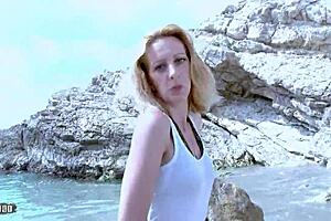 A mature woman with small bosom performs a striptease