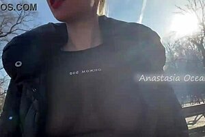 Beautiful woman showing her big boobs in a public park