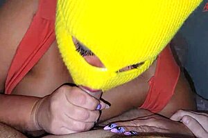 A mature woman gives oral sex to her husband while wearing a mask