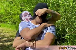 Muscular men in masks have rough outdoors sex