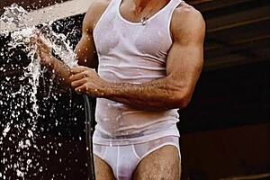 Muscular hunk gets double penetration in a group sex scene