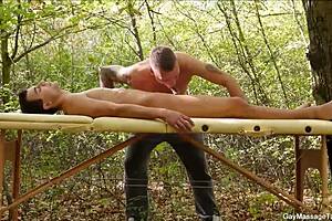 Young gay guys giving blow jobs during a hot massage with outdoor scenery