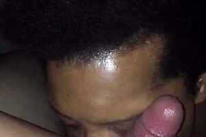 A black gay man enjoys giving oral sex to a white man