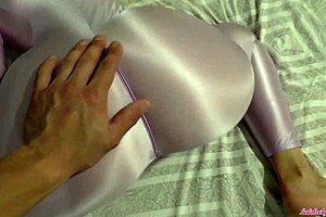 Beautiful woman in sexy nylon lingerie gives a sensual massage with a hand job
