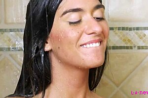Pretty brunette gives a shower time twist and turns it into an erotic experience