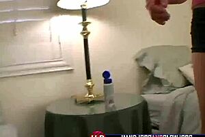 A beautiful blonde teenage girl gives a hand job to a man