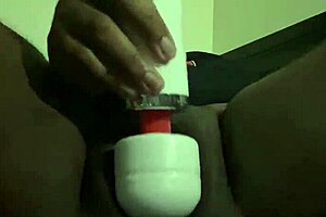 A black goth enjoys using a vibrator