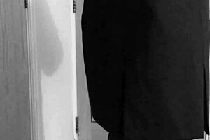 A crossdresser in self-bondage in a uniform