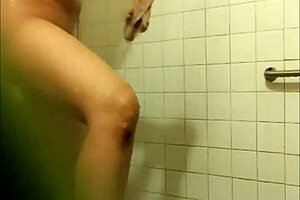A mature Chinese woman washes her long hair in the bathroom