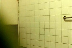A mature Chinese woman washes her long hair in the bathroom