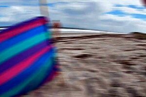 Young wife gives old man a handjob on the beach