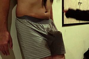 A woman uses my cock and balls as a sandbag and a man beats me, why do I still get an erection?