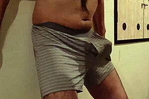 A woman uses my cock and balls as a sandbag and a man beats me, why do I still get an erection?