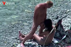A daring wife gets fucked on the beach by voyeurs