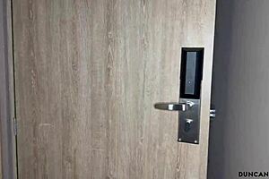The red-haired girl handed over the key to her room with a playful gesture
