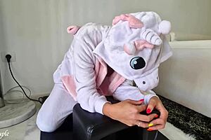 A hot MILF in a unicorn costume rides Sybian with passion
